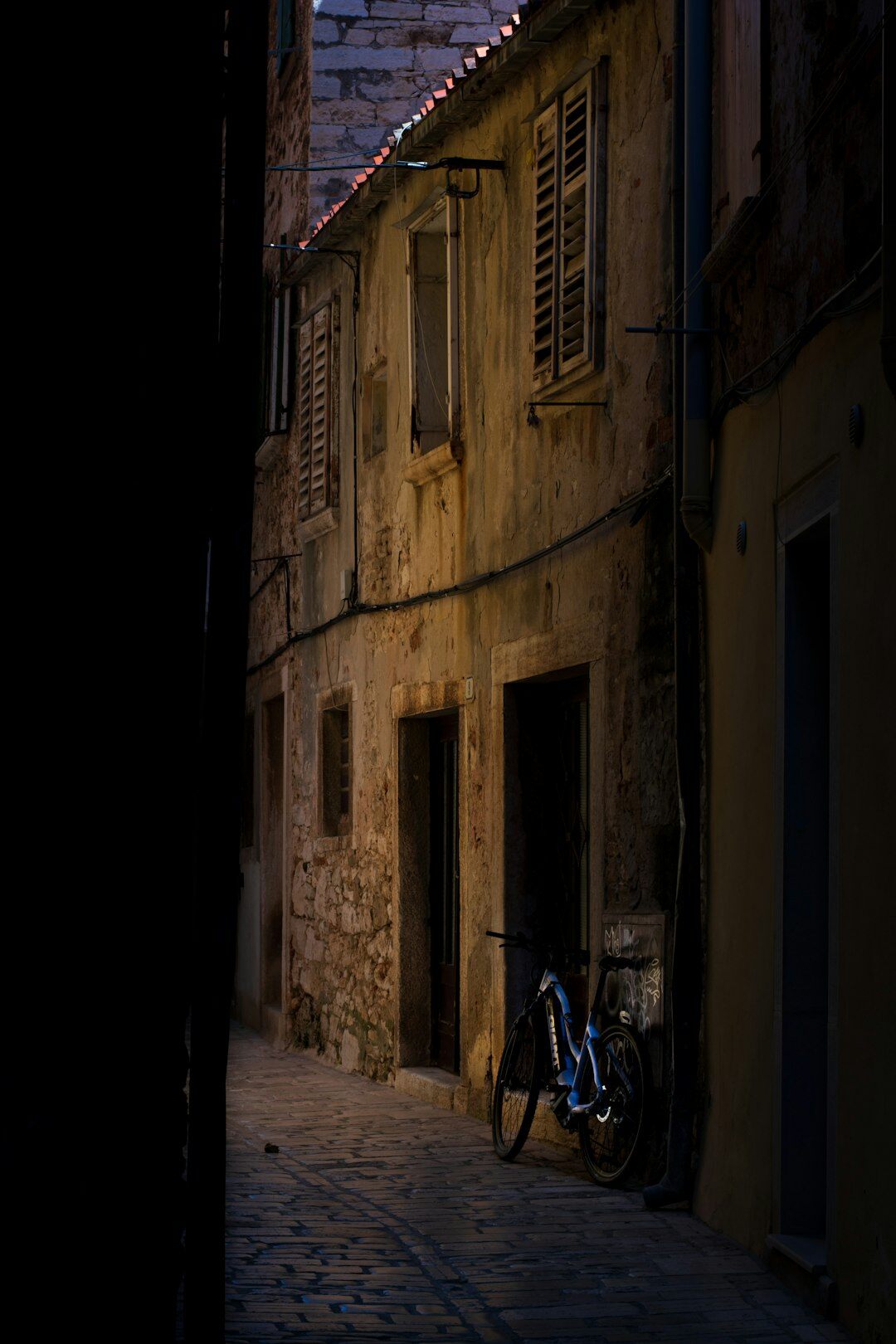 Documentary photographer taking pictures in a stone Croatian village street