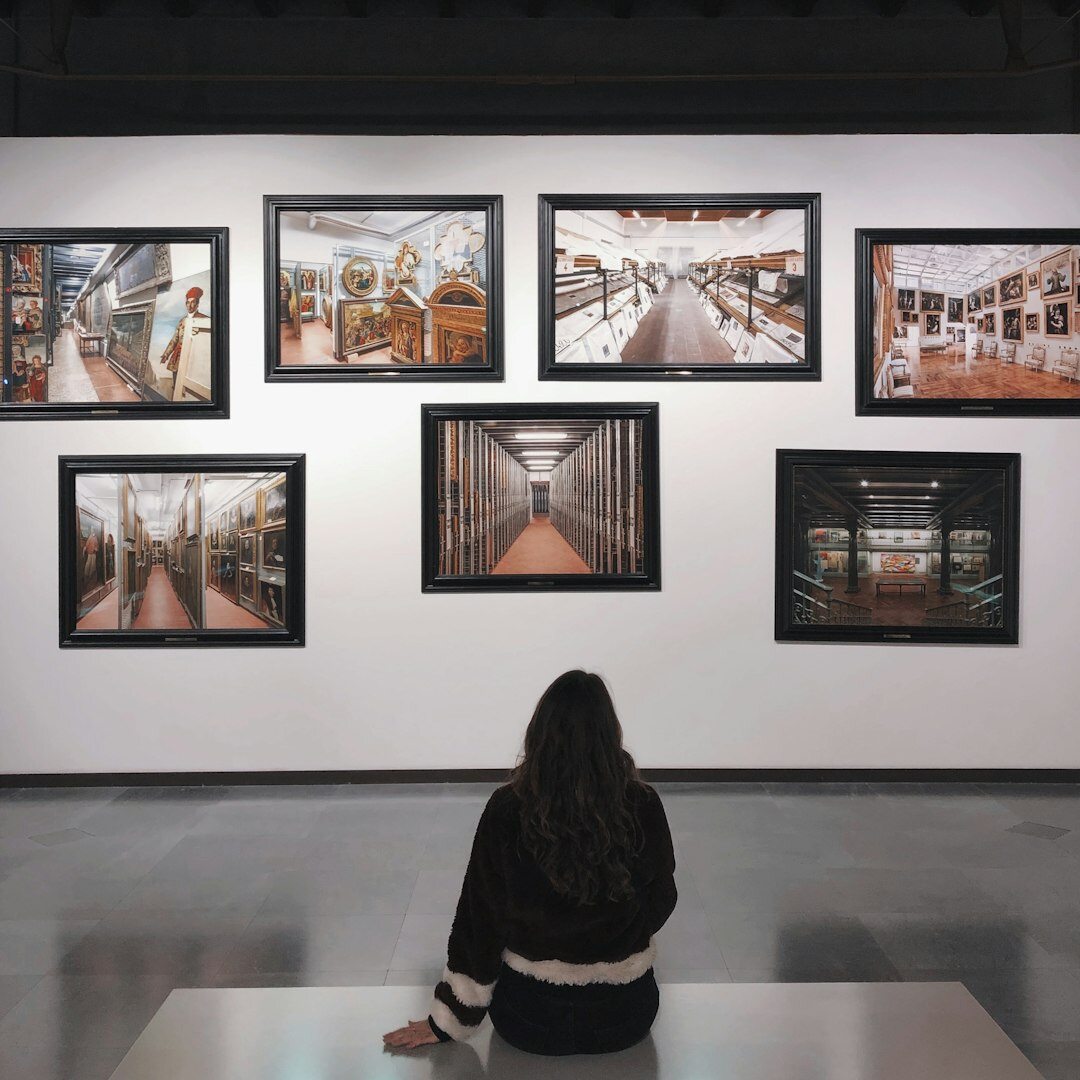 Framed documentary photographs displayed at a small gallery exhibition