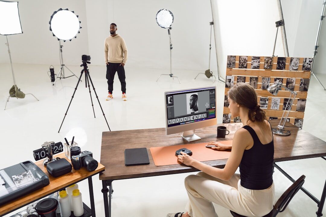 Photographer editing documentary photographs on a computer in a studio